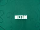 Small white component photographed on a green surface