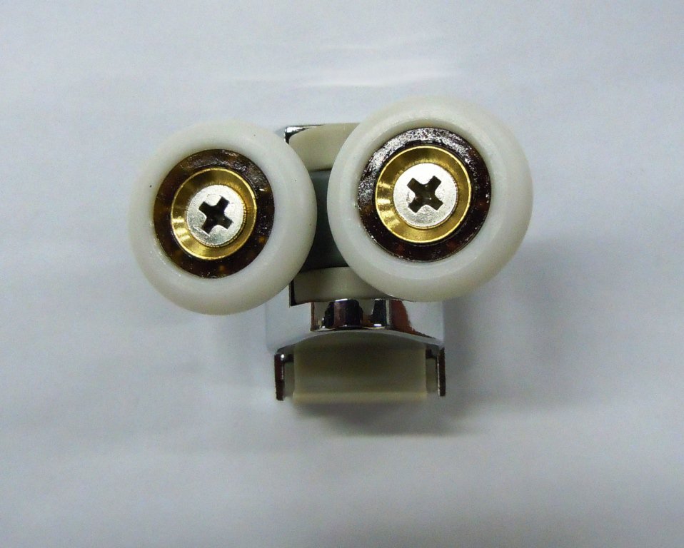 Two wheels side by side, each with a metal centre, with a supporting part below them, on a light background